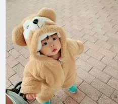 SSJ3 baby suit in tan with bear hood, worn by a child outdoors